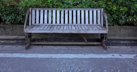 A bench in a public park, on a spring or summer day. A wooden bench for rel.. Stock Photos