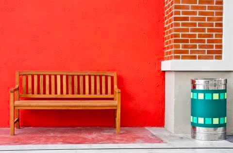 Bench on red wall. Stock Photos