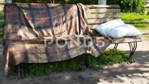 Bench with rug and pillow Stock Photos