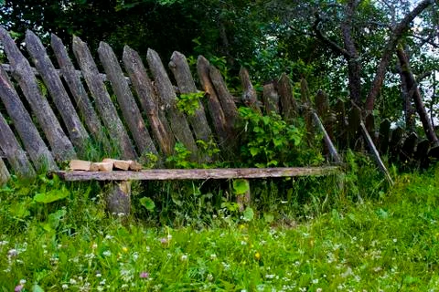 Bench in a sagging fence Stock Photos