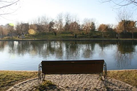 Bench On The Side Of A Lake Stock Photos