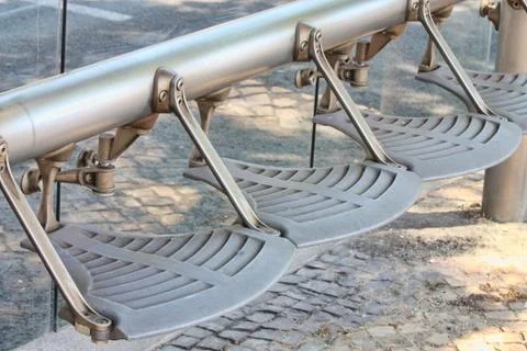 Bench on sidewalk Stock Photos