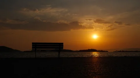 Bench silhouette on bay by waves. Stock Footage 285563337