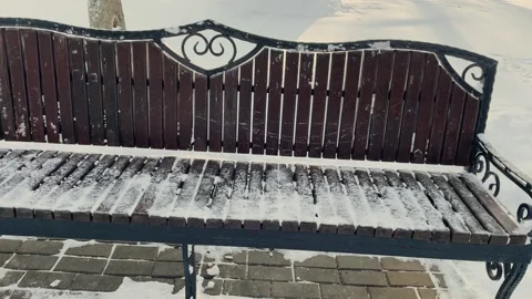 A bench in the snow in the park Stock Footage 329250077
