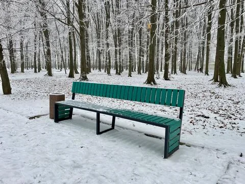 Bench in the snow in park Stock Photos