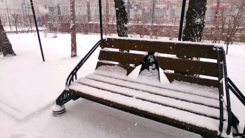 Bench in the snow on the street Stock Footage 221729257