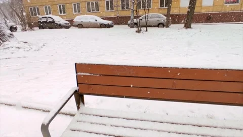 Bench in the snow on the street Stock Footage 221730228
