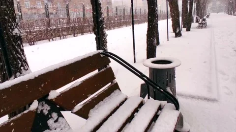 Bench in the snow on the street Stock Footage 221730595