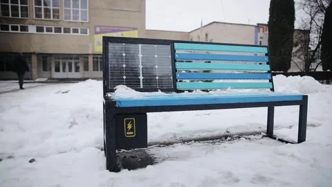 The bench with a solar panel for electricity energy generation in winter season Stock Footage 259208203