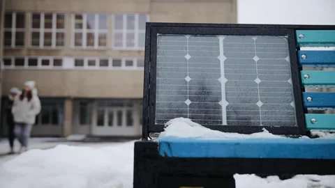 Bench with solar panel on the street in winter. Renewable energy, green power Stock Footage 258679656