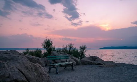 Bench in sunset at sea Stock Photos