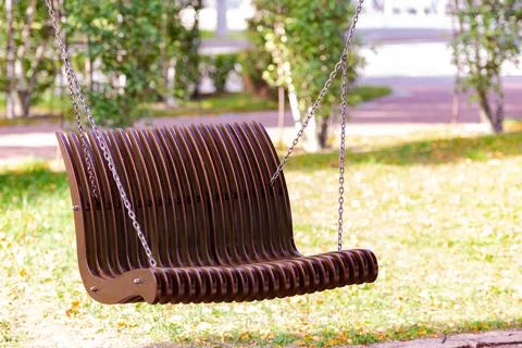 A bench suspended by chains Stock Photos