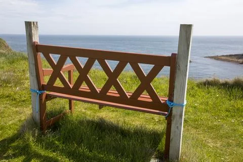 A bench tied down to stop it blowing away in the high winds on the SE tip of  Stock Photos