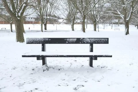 Bench under snow in winter Stock Photos