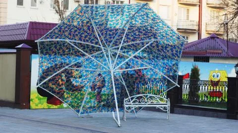 Bench under the umbrella Stock Photos