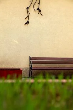 Bench at the wall in Riga city. Stock Photos