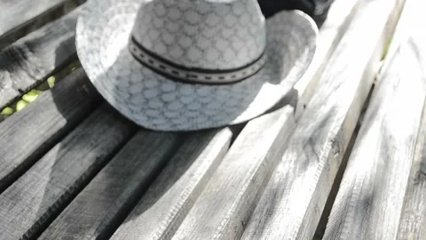 On bench white hat Stock Footage 95642764