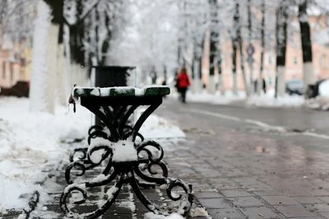 Bench winter sidewalk Stock Photos