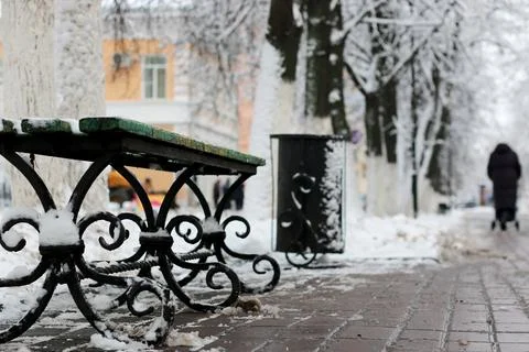 Bench winter sidewalk Stock Photos