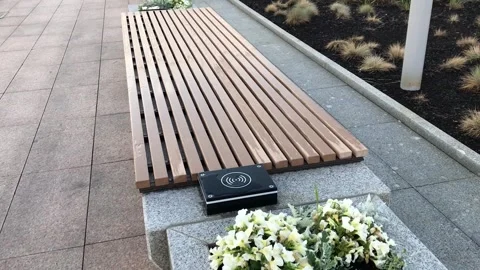 Bench with wireless charging for smartphone, park public place infrastructure 스톡 동영상 248135438