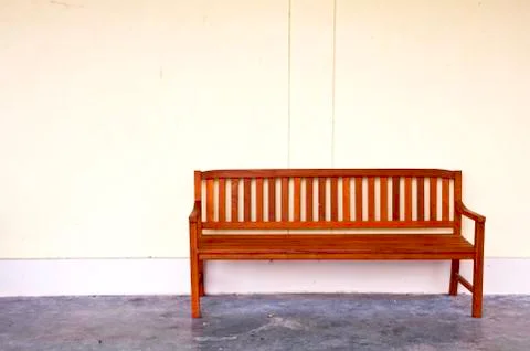Bench on yellow wall. Stock Photos