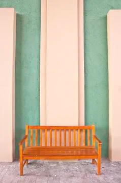 Bench on yellow wall. Stock Photos