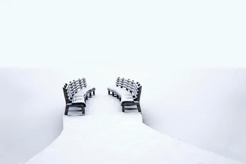 Benches on jetty in winter Stock Photos