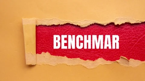 Benchmark message written on ripped torn paper background Stock Footage 317391920