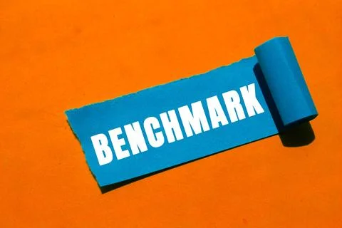 Benchmark message written on ripped torn paper background. Conceptual Bench.. Stock Photos