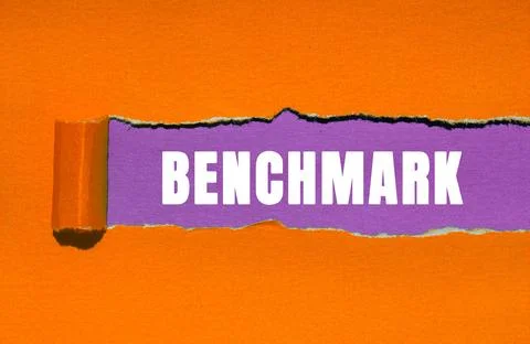 Benchmark message written on ripped torn paper background. Conceptual Bench.. Stock Photos