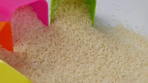 Bend plastic glasses half filled with rice Stock Footage 147693846