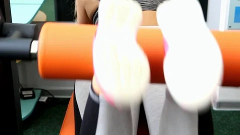 Bending female legs on a simulator, close plan Stock Footage 115624334