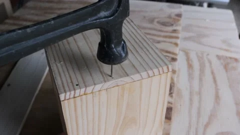 Bending nail while attempting to hammer box together. Stock Footage 143059549
