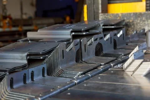 Bending of sheet metal using a hydraulic machine for bending metal sheets. Stock Photos