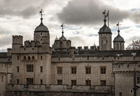 Beneath a brooding, silver-edged sky, the Tower of London stands as a formi.. Stock Photos