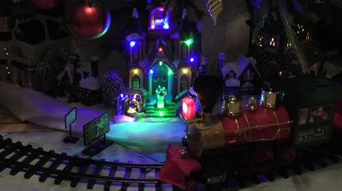Beneath Christmas tree lights baubles globes decorations train Stock Footage 59034310