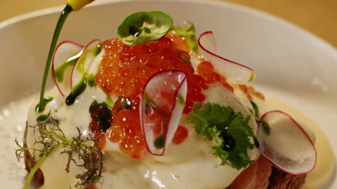 Benedict egg toast poured on top with green oil dressing and sea salt flakes Stock-Footage 151295525