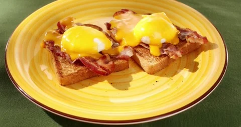 Benedict eggs on a plate. Colored background. Smooth camera movement. Zoom in. Stock Footage 242411287
