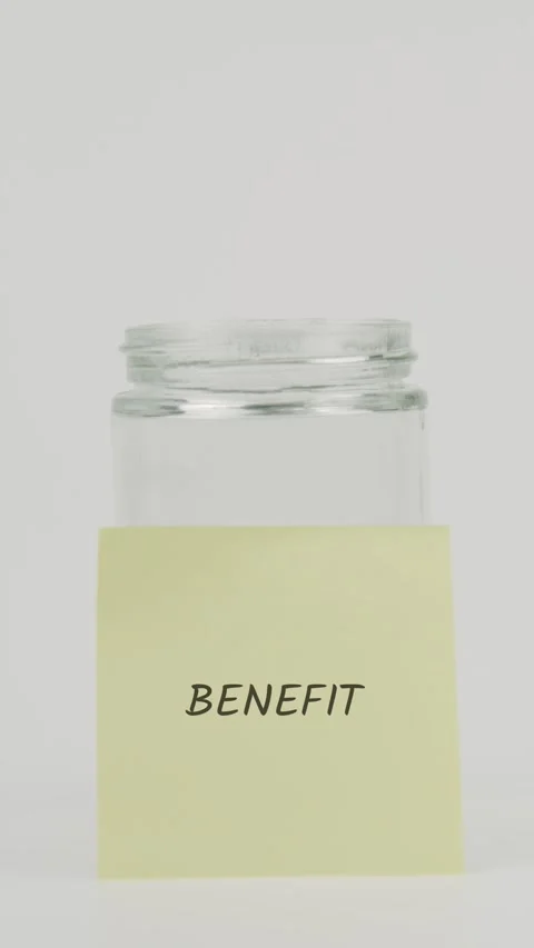 Benefit text or word on yellow sticky note attached to glass jar with hand Stock Footage 311680801