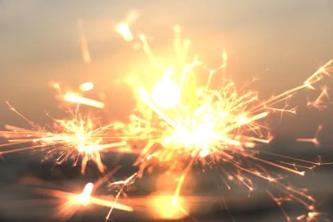 Bengal fire on a background of colored sunset Stock Photos