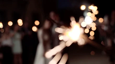 Bengal fire is burning against the background of the newlyweds. Slow motion. Video stock 97168636