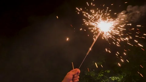 Bengal lights burning in a persons hand Stock Footage 329249823