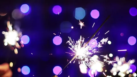 Bengal lights in hands against the background of New Years lights on Christmas Stock Footage 293683257
