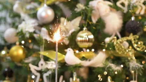 Bengal sparkling fire in front of beautiful Christmas tree with ornaments Vídeo Stock 166537359