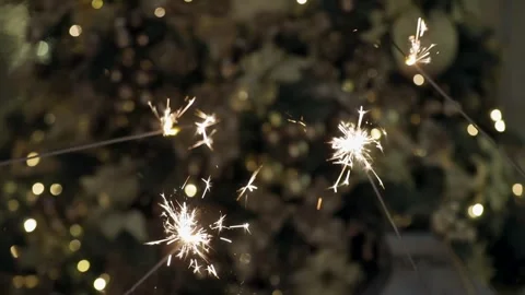 Bengali lights are sparkling in front of decorated christmas tree. Stock Footage 251529412