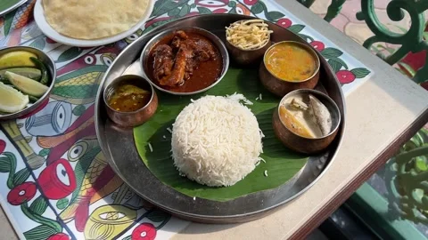 Bengali mutton thali served with lentils, rice, mutton in banana leaf in India Video stock 310867488