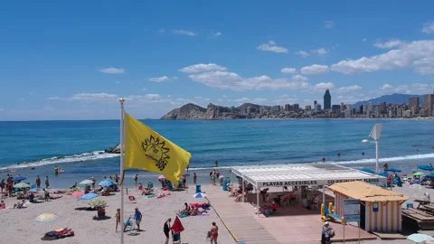 Benidorm Beach views during summer Aerial Footage Blue sky Yellow Flag Stock Footage 130644358