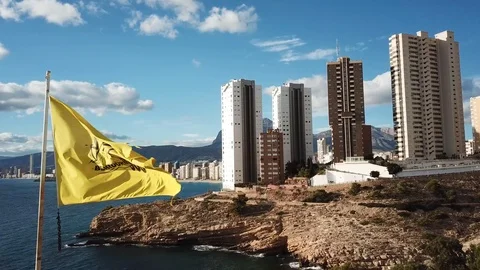 Benidorm Flag reveal to Beach and Buildings. Drone 4K. Spain. Stock Footage 113613975