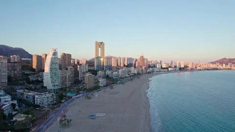 Benidorm Playa de Poniente beach at sunset with tall buildings. Stock Footage 232877323