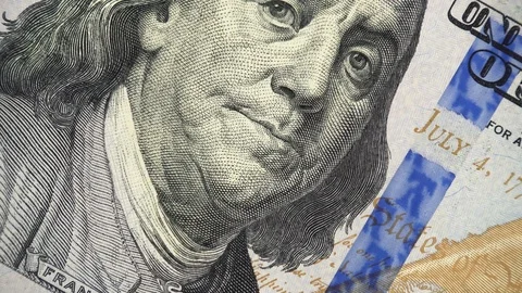 Benjamin Franklin face on new US 100 dollar bill rotating, money close up Stock Footage 99145568